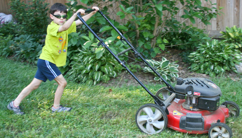 Kid mows the lawn
