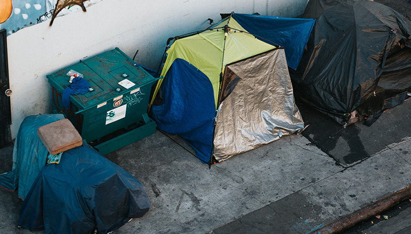 Group of tents on a sidewalk; homeless people