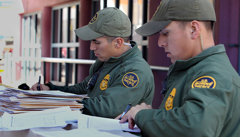 CBP Border Patrol agents complete official paper work after completing bus security at Nogales port of entry, DeConconi.